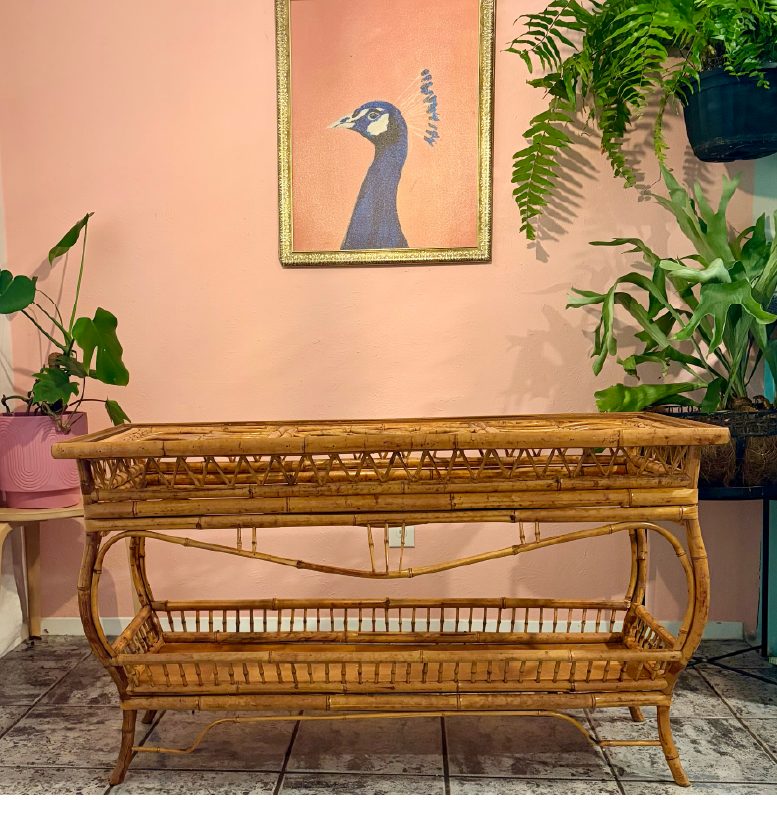 A styled Austin showroom corner with a vintage rattan console